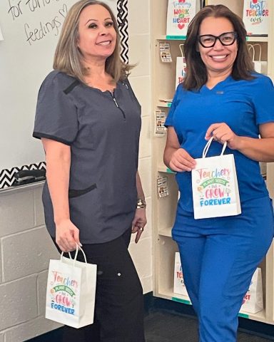 A quick pose with their appreciation bags